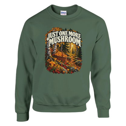 Just One More Mushroom - Sweatshirt in Military Green. Golden mushrooms in a wicker basket on a mossy forest floor beneath Just One More Mushroom lettering.