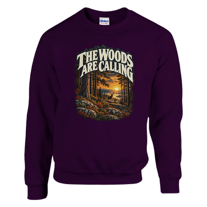 The Woods Are Calling - Sweatshirt in Maroon. A deer between tall pine trees in golden light beneath The Woods Are Calling lettering.