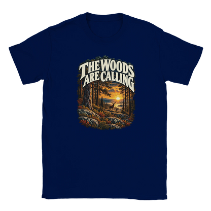 The Woods Are Calling - T-shirt in Navy. A deer between tall pine trees in golden light beneath The Woods Are Calling lettering.