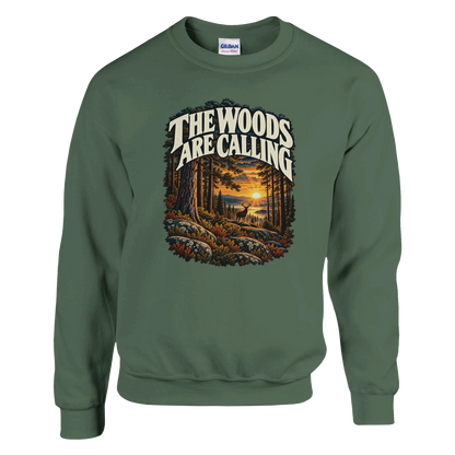 The Woods Are Calling - Sweatshirt in Military Green. A deer between tall pine trees in golden light beneath The Woods Are Calling lettering.